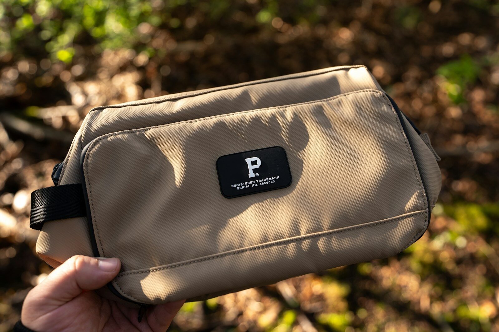 Hand holding a pouch with a patch