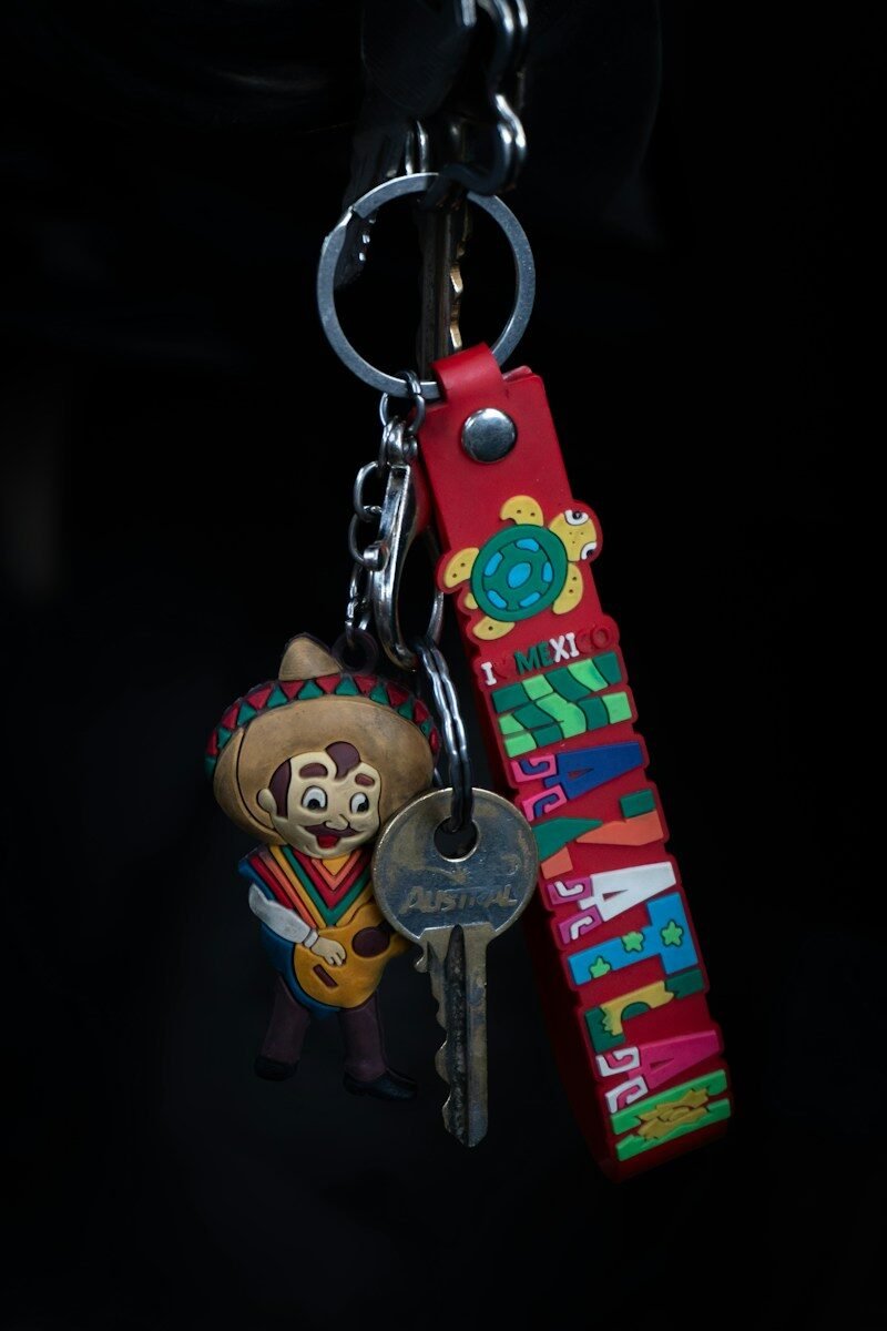 Keys on a keychain with a colourful PVC charm